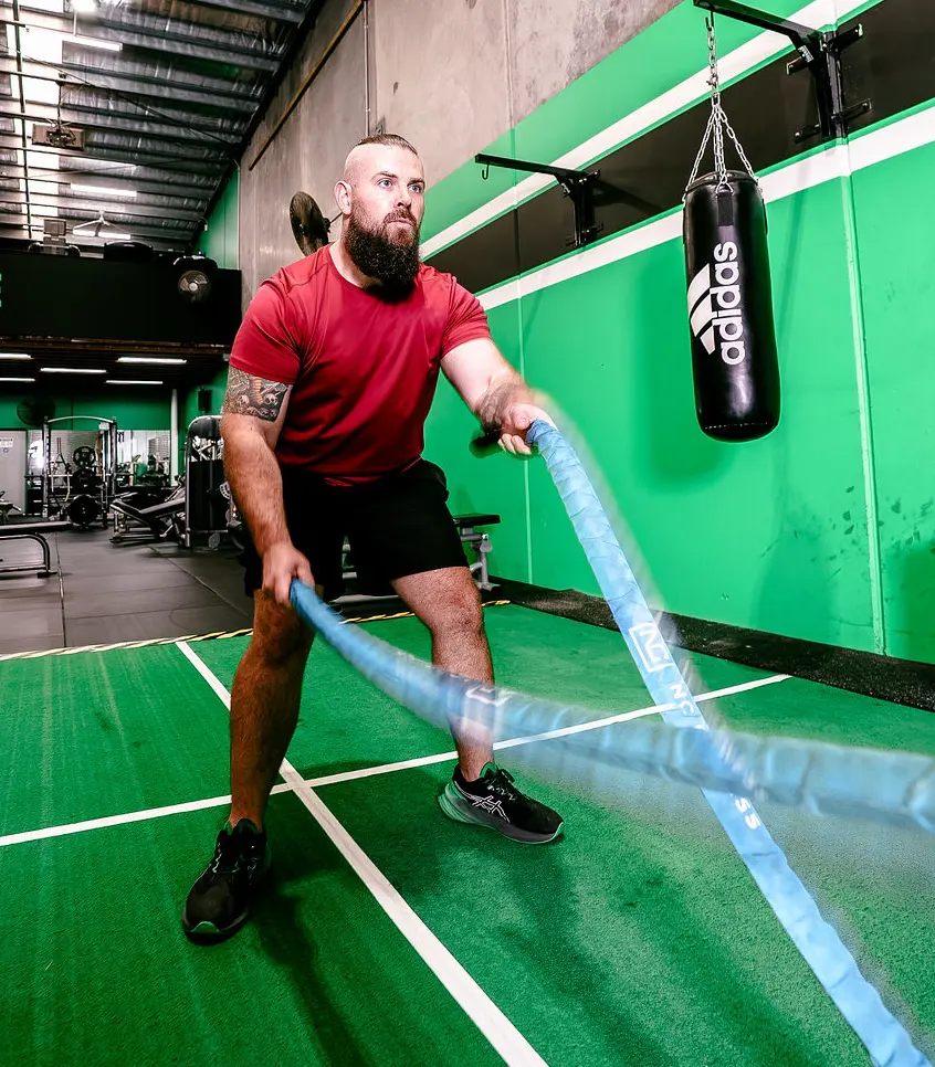 Matt, strength and conditioning coach, training with battle ropes